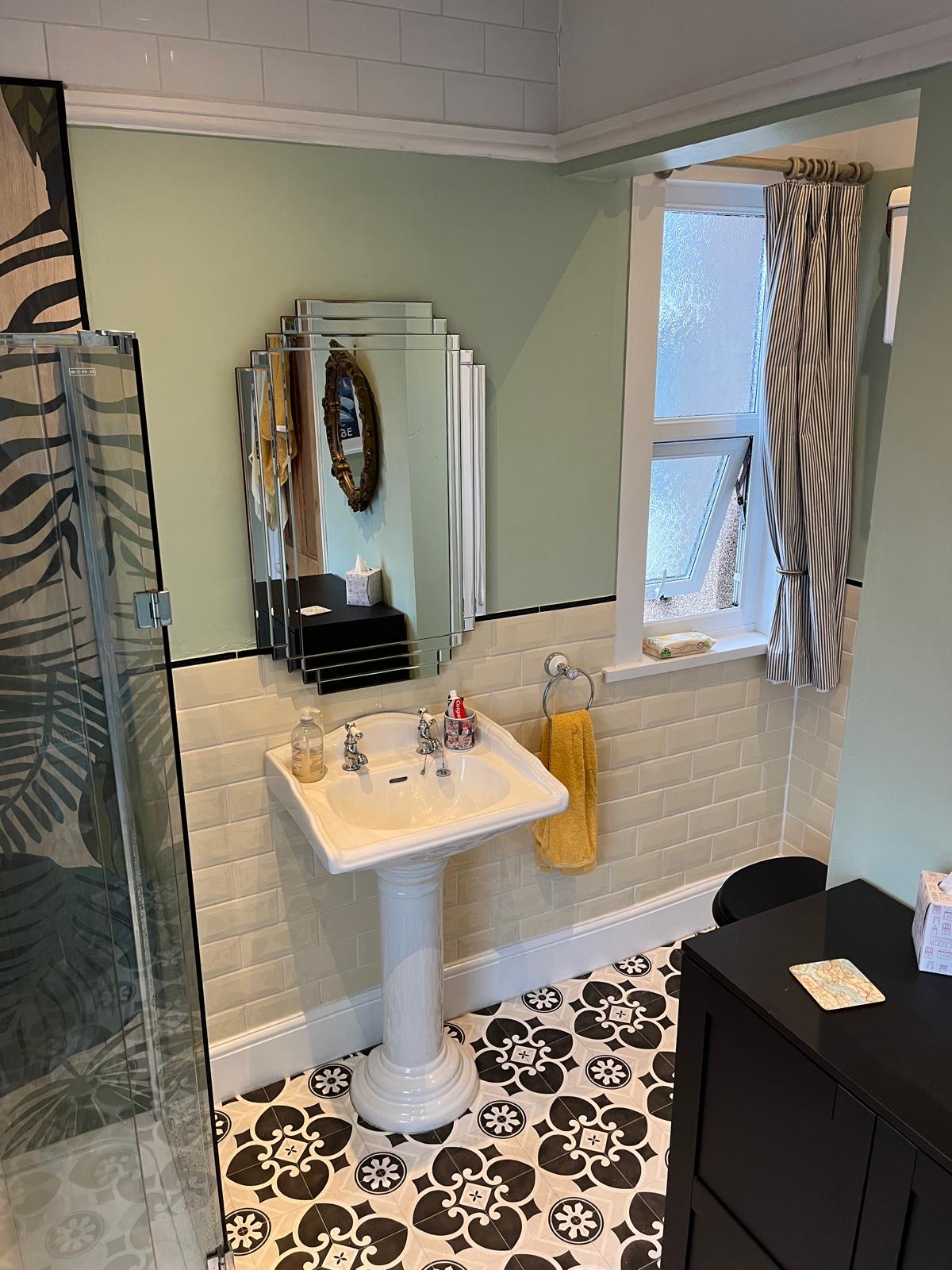 Completed botanical bathroom with pedestal basin and patterned floor